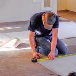 Young,Man,Carpenter,Measuring,New,Rugs,He's,Going,To,Install