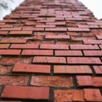 A,Heavily,Damaged,Brick,Chimney,On,A,House