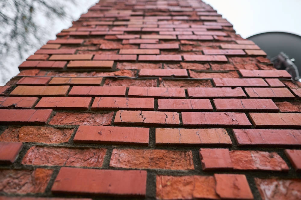 A,Heavily,Damaged,Brick,Chimney,On,A,House