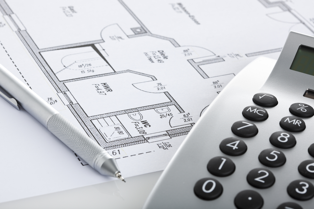 Mechanical,Pencil,And,Calculator,On,Blueprint,Of,Floor,Plan,,Close